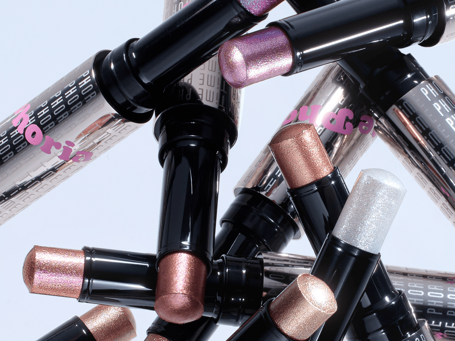 Fingertip blending pink-purple Illumina Jelly Eyeshadow Stick across an eyelid. 
