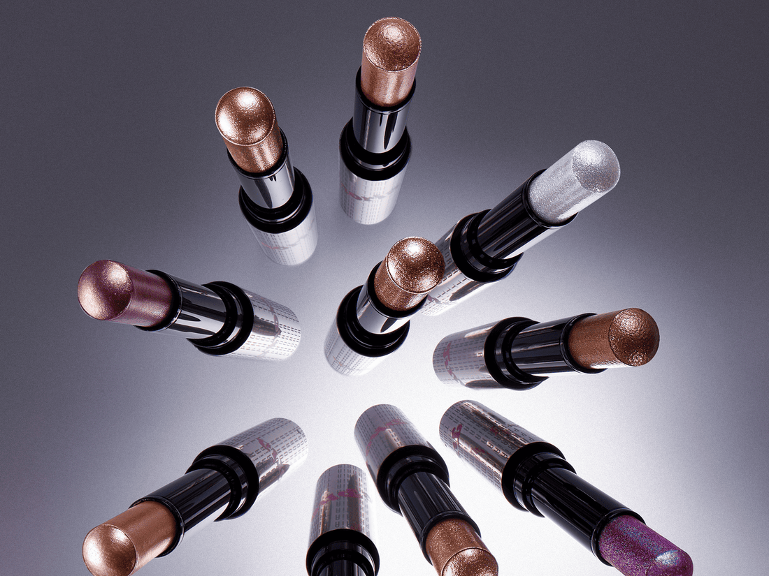 Fingertip tapping the edge of purple metallic eyeshadow on a closed eyelid.  